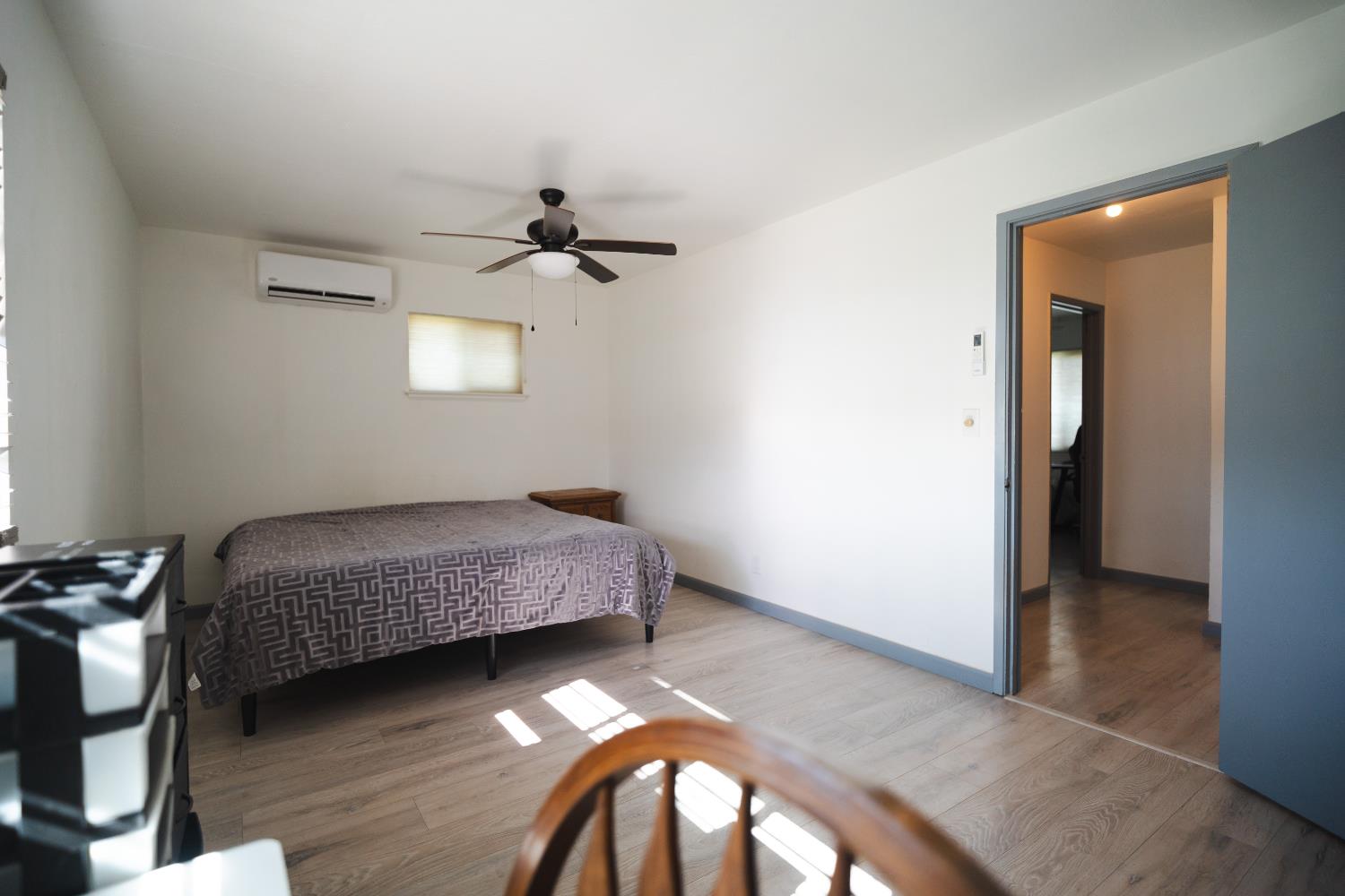 4551 Wheatland Road Wheatland, CA 95692 - Photo 9 of 50 a bedroom with a bed and a chandelier