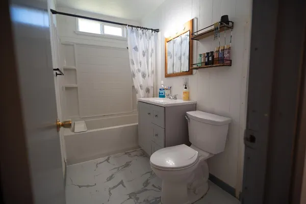 a bathroom with a toilet sink and shower