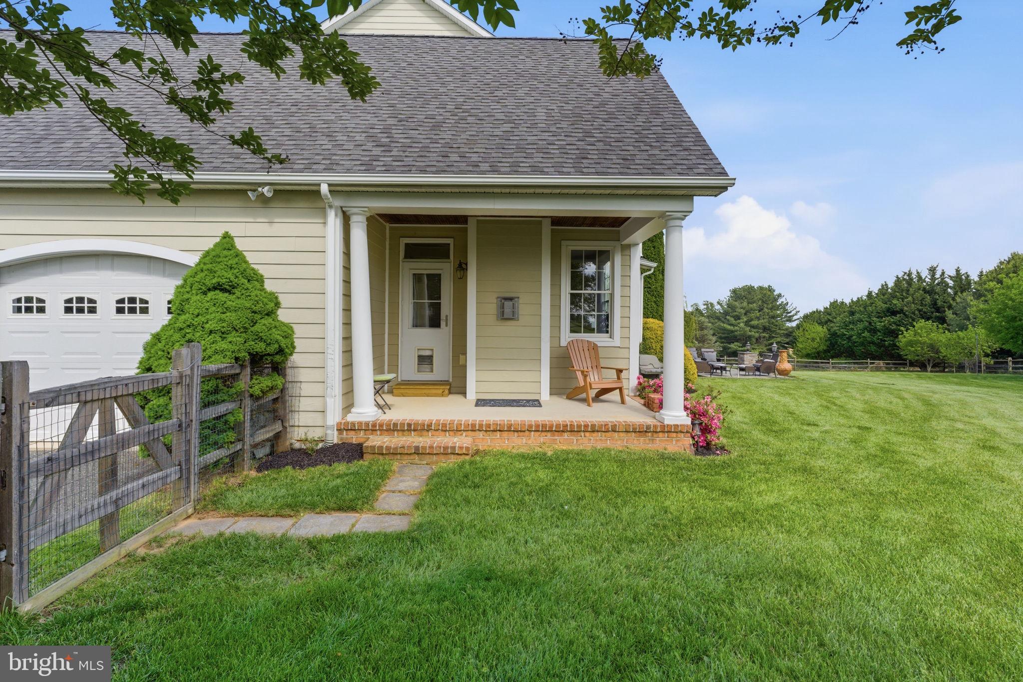 9 Deer Ridge Court Phoenix, MD 21131 - Photo 40 of 96 a view of a house with a yard potted plants and a table