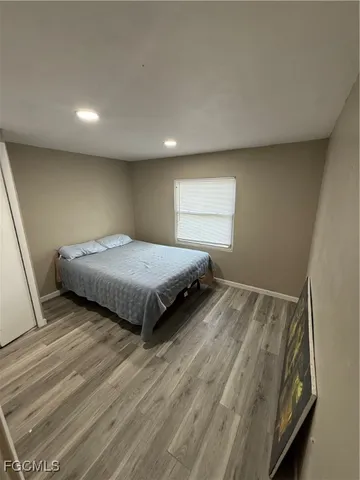 a bedroom with a bed and a mirror