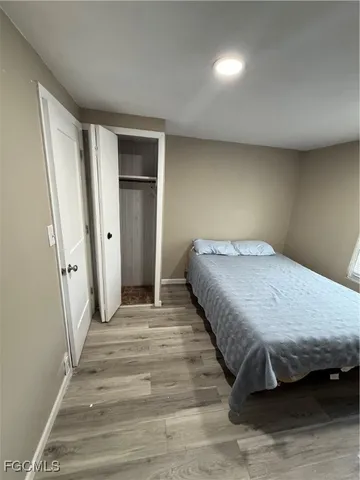 a spacious bedroom with a bed and a table