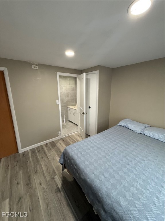 6671 Keystone Court North Port, FL 34287 - Photo 17 of 20 a spacious bedroom with a bed and a table