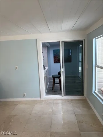 a kitchen with kitchen island a stove a table and chairs in it
