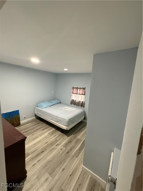 6671 Keystone Court North Port, FL 34287 - Photo 9 of 20 a bedroom with a bed and wooden floor