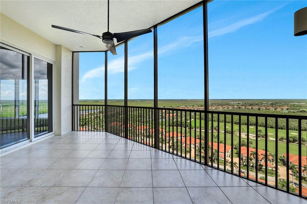 1060 Borghese Lane, Unit 2001 Naples, FL 34114 - Photo 27 of 35 Unfurnished sunroom with expansive windows, a textured ceiling, and tile patterned floors
