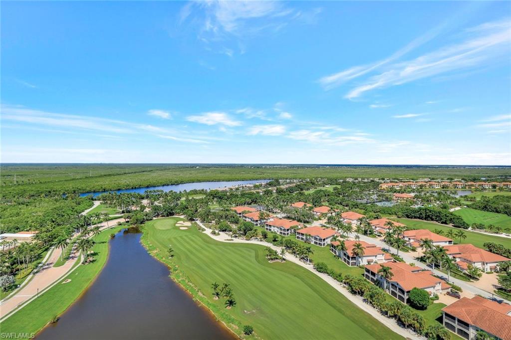 1060 Borghese Lane, Unit 2001 Naples, FL 34114 - Photo 31 of 35 Aerial perspective of suburban area featuring a golf club and a nearby body of water