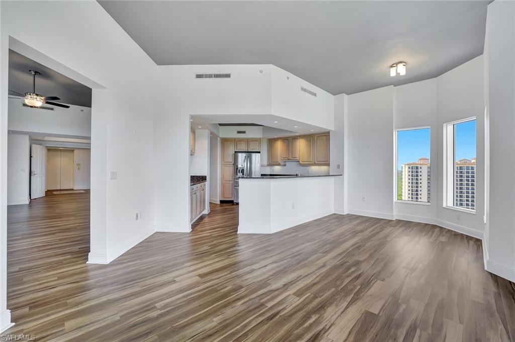 1060 Borghese Lane, Unit 2001 Naples, FL 34114 - Photo 6 of 35 Unfurnished living room with light wood-type flooring and ceiling fan