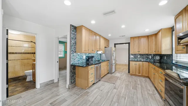 a view of a living room and kitchen with a large window