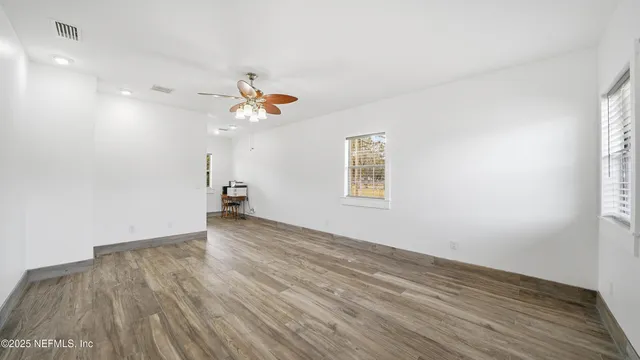 wooden floor in an empty room with a window