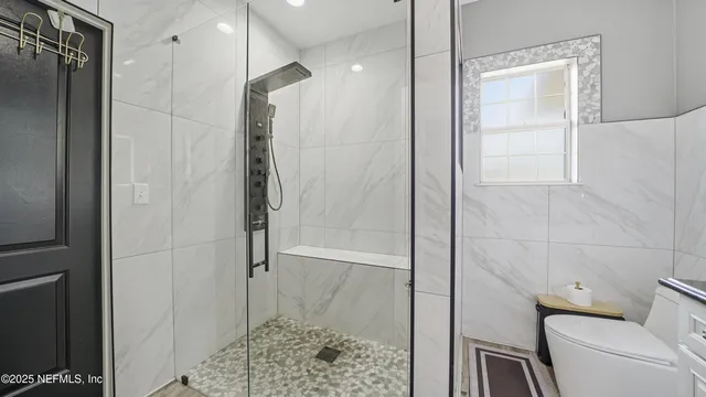 a view of empty room with window and ceiling fan