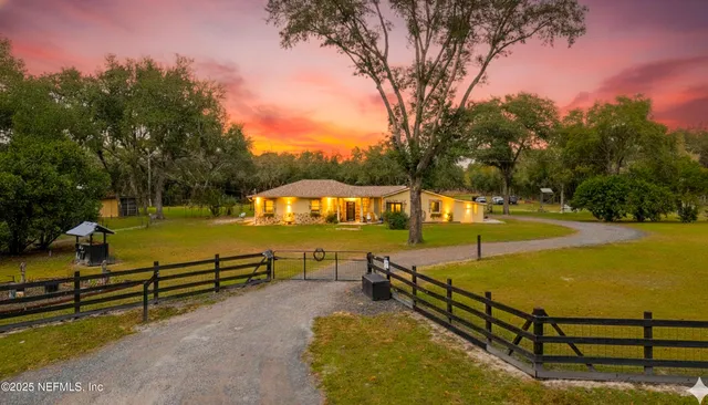 a view of a swimming pool with a bench and trees around