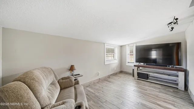 a house view with swimming pool and trees in the background