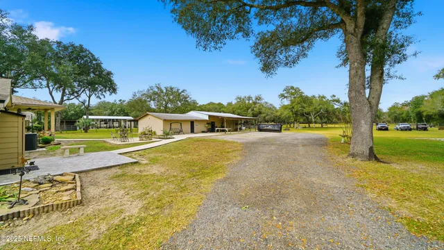 a view of a swimming pool with a patio and a yard