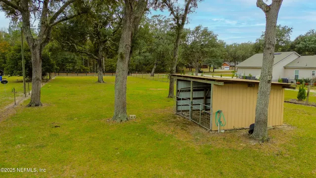a view of outdoor space with yard and trees all around