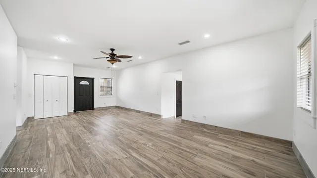 a view of a livingroom with a ceiling fan and window