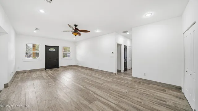 a view of a kitchen with wooden floor and staircase