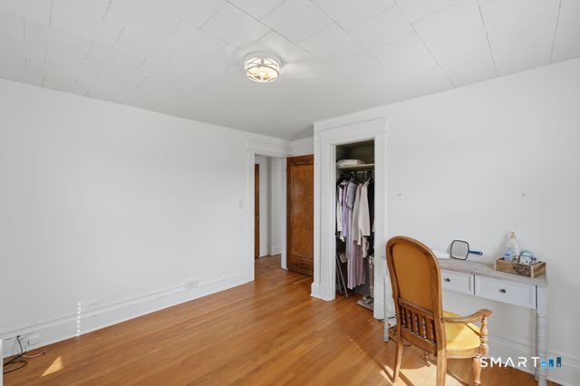 443 Highland Avenue Waterbury, CT 06708 - Photo 15 of 24 a view of a workspace with furniture and wooden floor