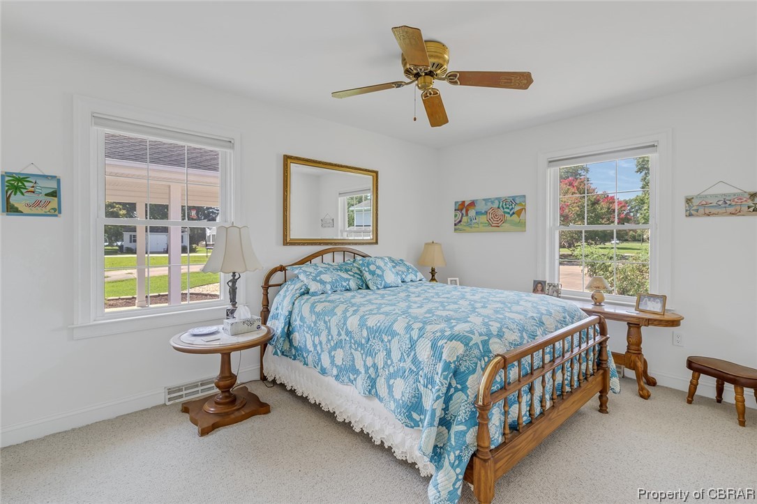 43 Locksley Court Reedville, VA 22539 - Photo 15 of 37 Carpeted bedroom featuring multiple windows and ceiling fan