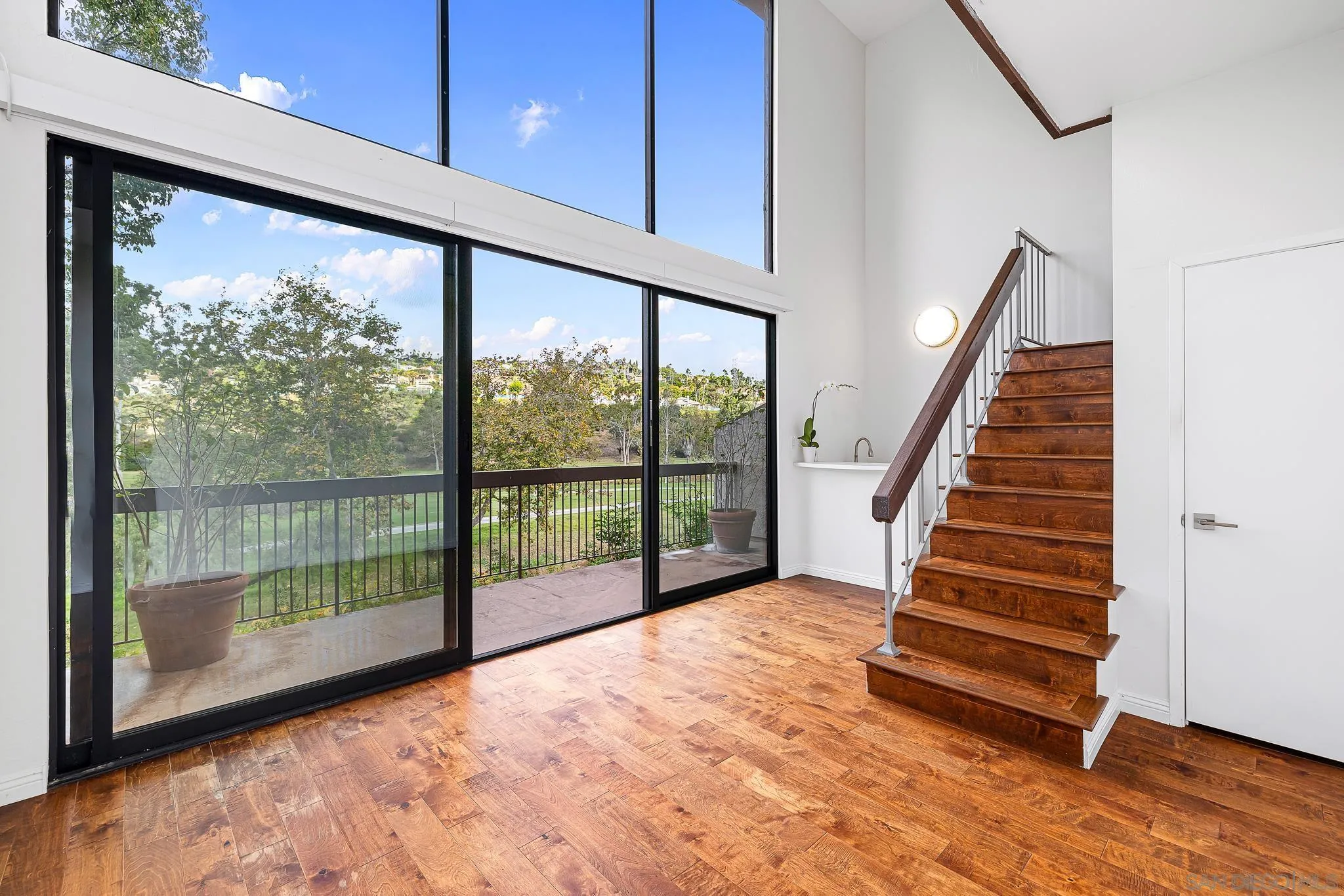 2564 Navarra Drive, Unit 108 Carlsbad, CA 92009 - Photo 15 of 23 a view of empty room with wooden floor and fan