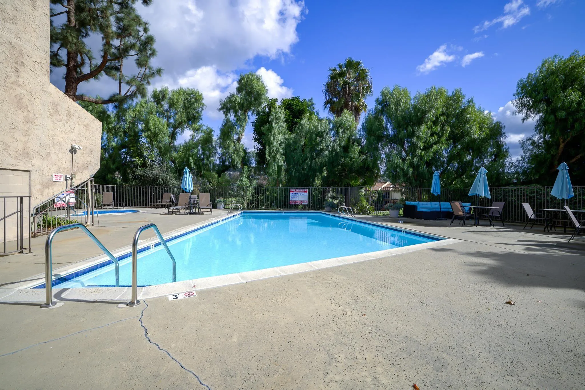 2564 Navarra Drive, Unit 108 Carlsbad, CA 92009 - Photo 22 of 23 a view of a swimming pool with a bench