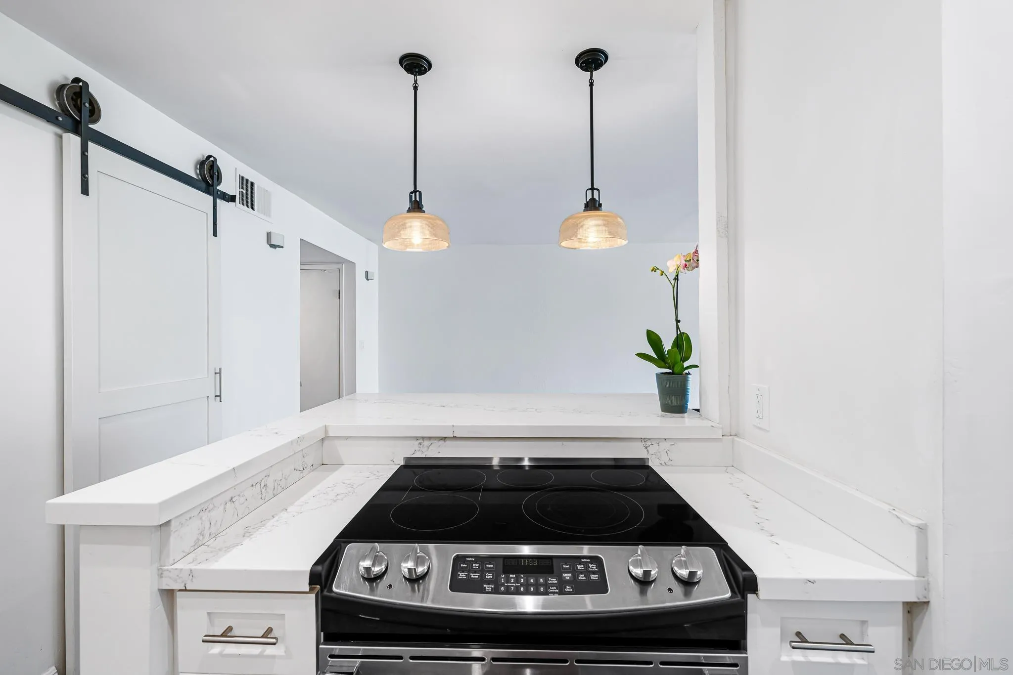 2564 Navarra Drive, Unit 108 Carlsbad, CA 92009 - Photo 9 of 23 a kitchen with a stove and a white cabinet