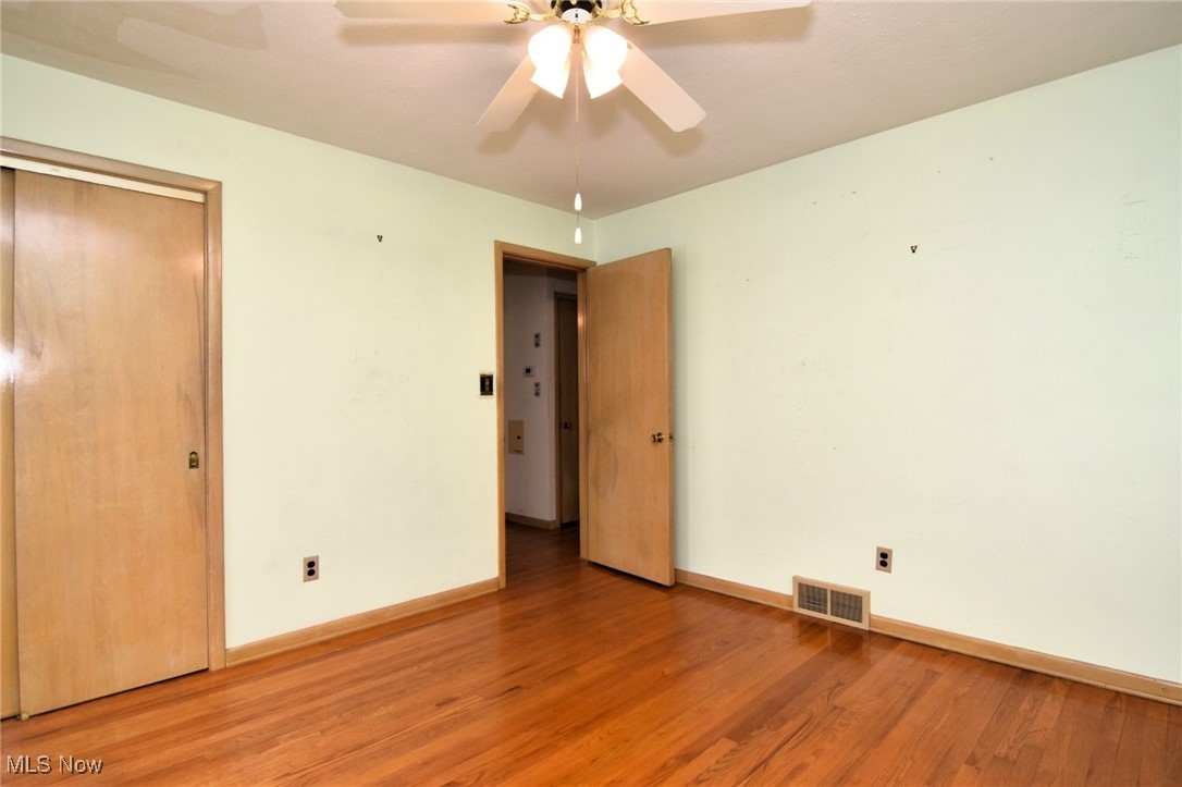 9421 David Road Cleveland, OH 44125 - Photo 22 of 36 Unfurnished bedroom with light wood-style floors, a closet, and a ceiling fan