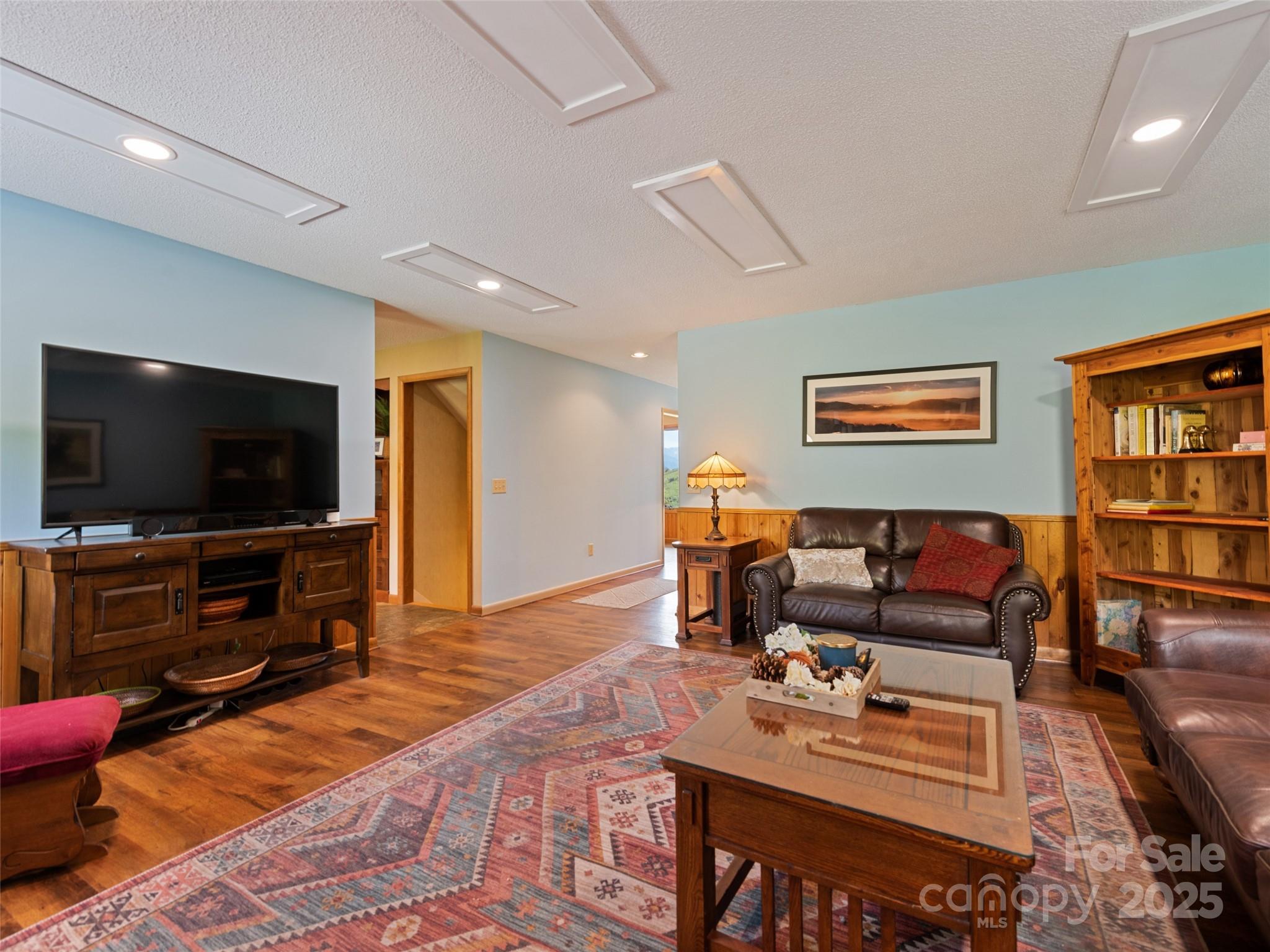 3735 Iron Duff Road Waynesville, NC 28785 - Photo 14 of 48 a living room with furniture and a flat screen tv