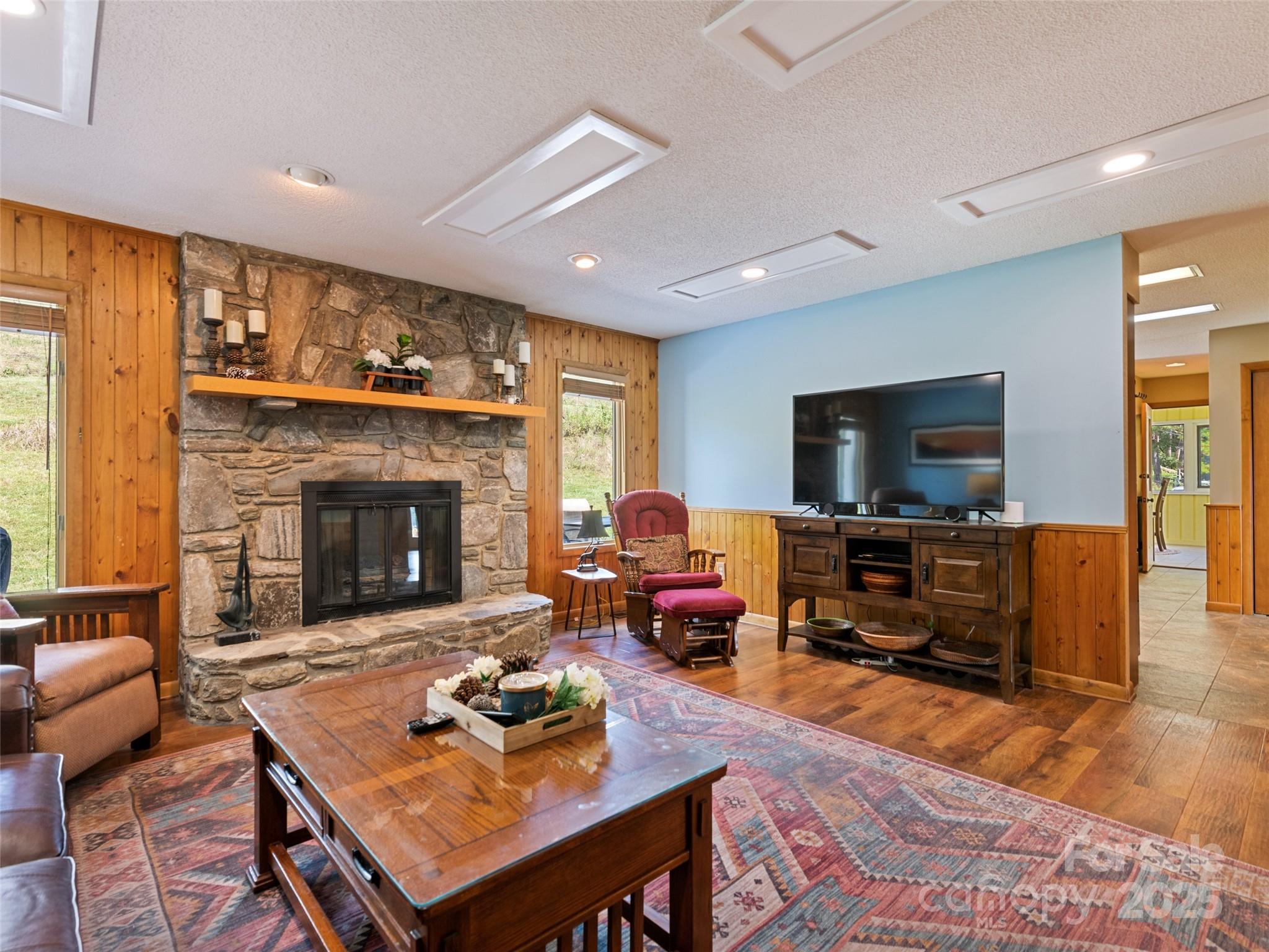3735 Iron Duff Road Waynesville, NC 28785 - Photo 15 of 48 a living room with furniture a flat screen tv and a fireplace