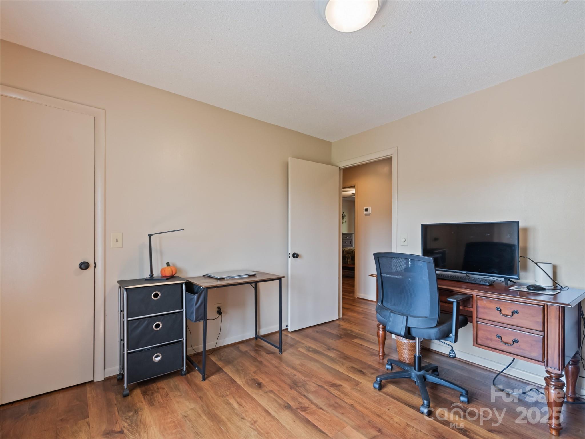 3735 Iron Duff Road Waynesville, NC 28785 - Photo 29 of 48 a view of a workspace with furniture and wooden floor