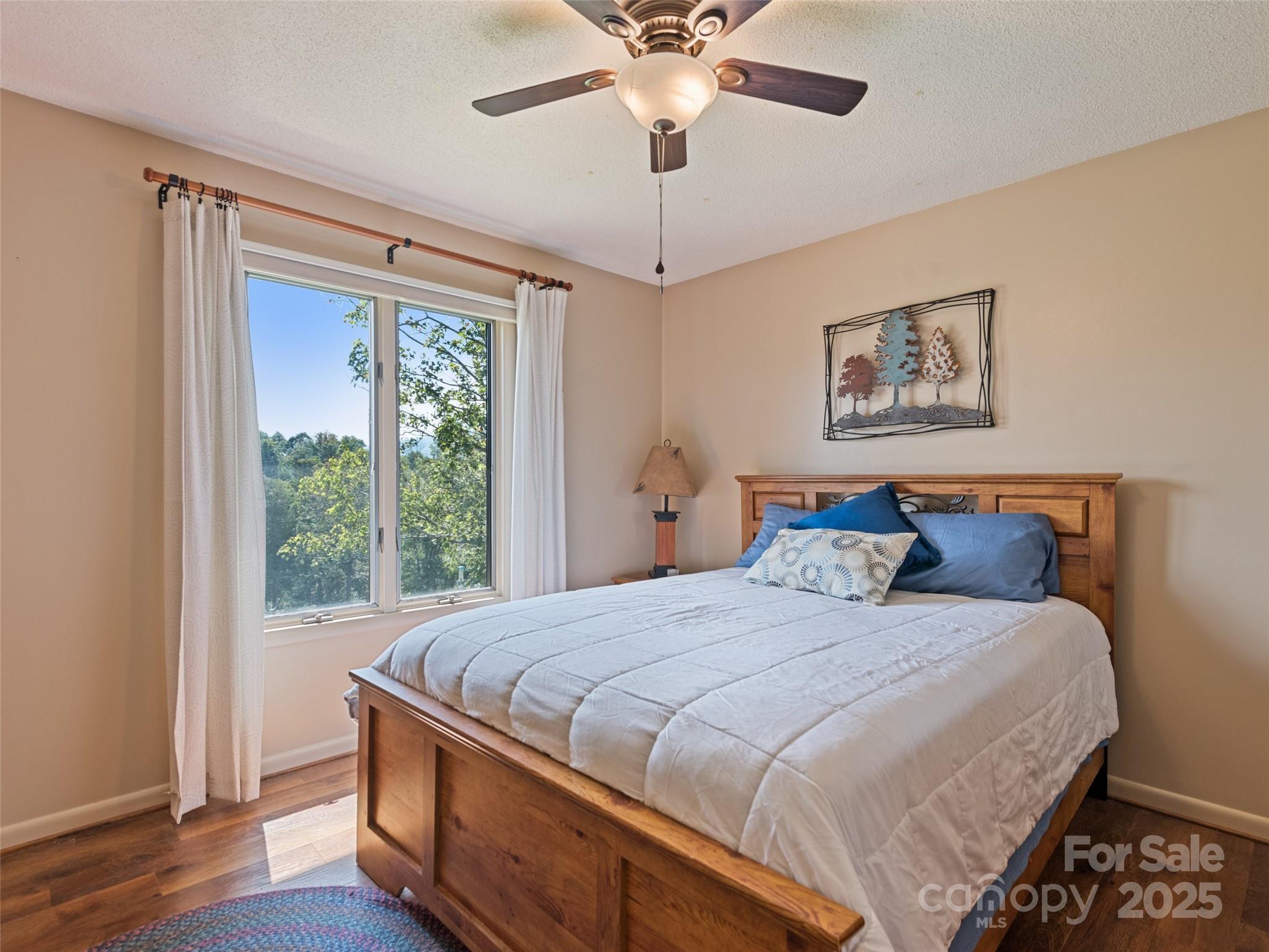 3735 Iron Duff Road Waynesville, NC 28785 - Photo 31 of 48 a bedroom with a large bed and a window