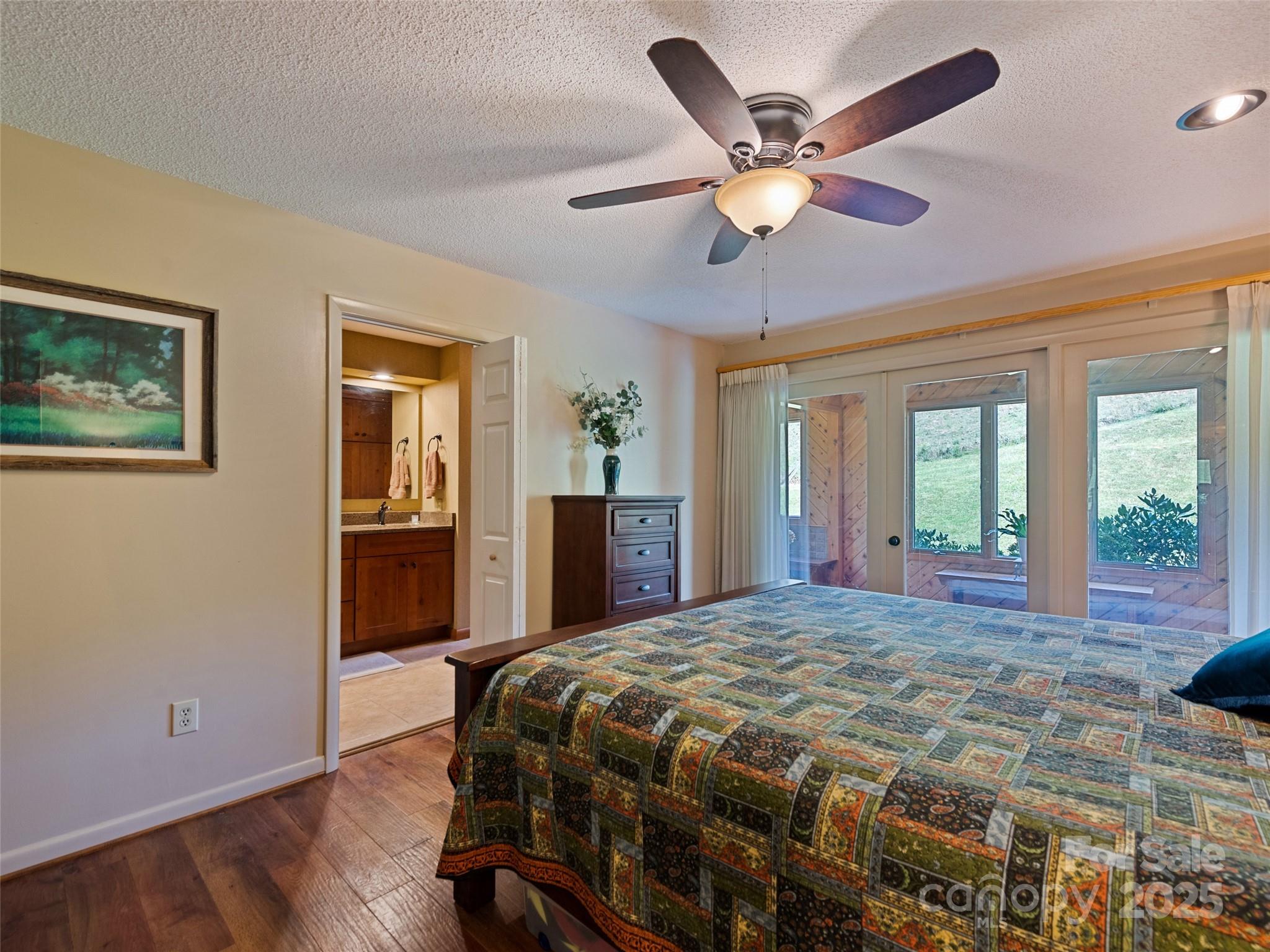 3735 Iron Duff Road Waynesville, NC 28785 - Photo 33 of 48 a bedroom with a large bed and a chandelier