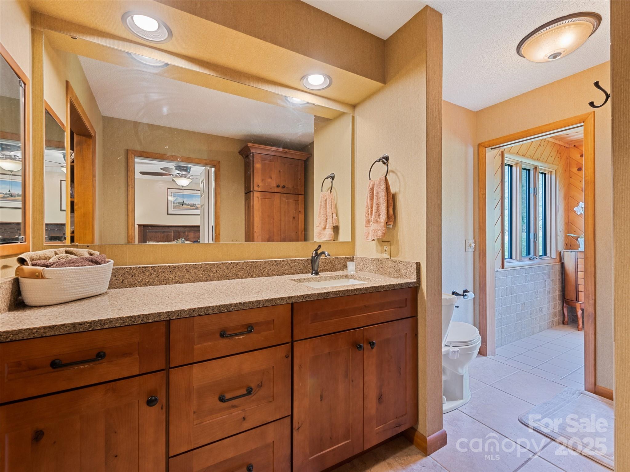 3735 Iron Duff Road Waynesville, NC 28785 - Photo 35 of 48 a spacious bathroom with a granite countertop sink and a mirror