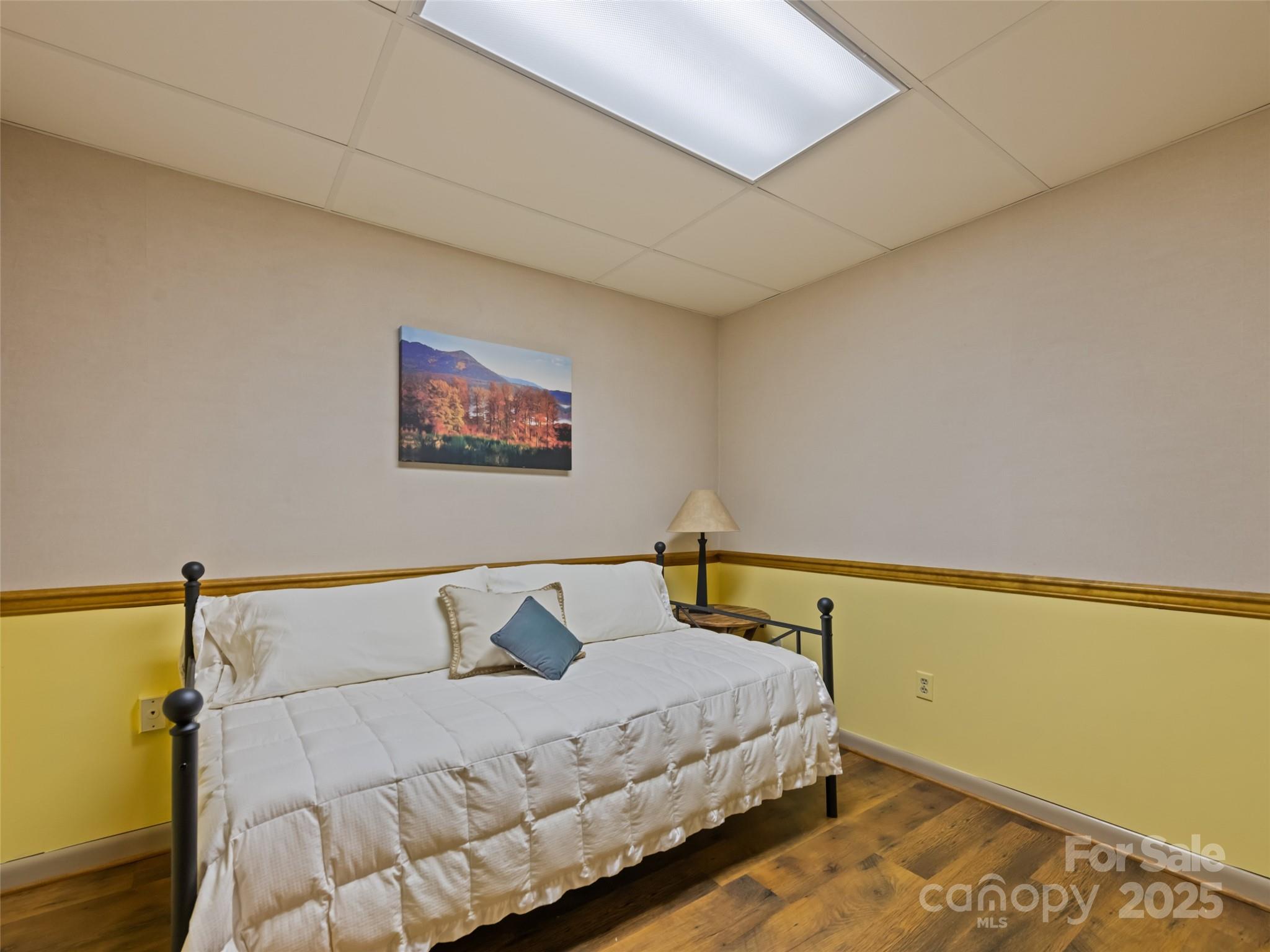 3735 Iron Duff Road Waynesville, NC 28785 - Photo 38 of 48 a bedroom with a bed and wooden floor