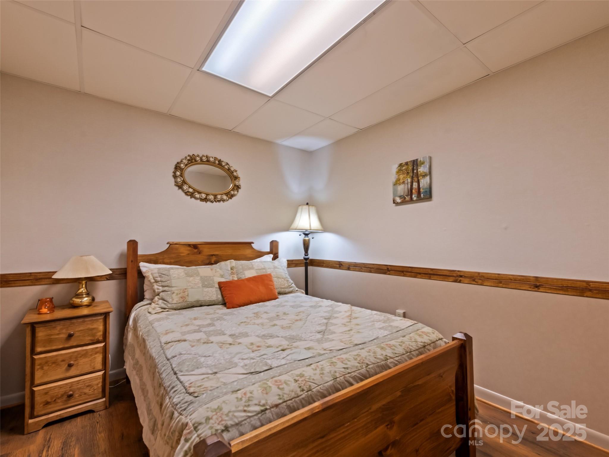 3735 Iron Duff Road Waynesville, NC 28785 - Photo 39 of 48 a bedroom with a bed and a lamp on dresser