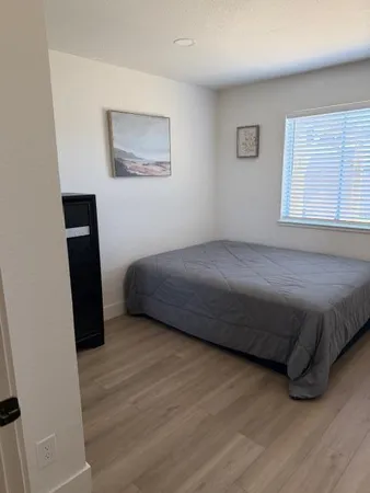 a bedroom with a bed and a window