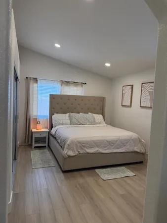 a bedroom with a bed and a night stand