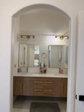 a bathroom with a double vanity sink and a mirror