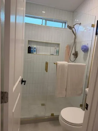 a bathroom with a toilet and shower