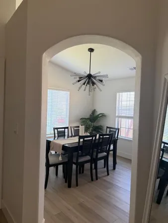 a view of a dining room with furniture and wooden floor