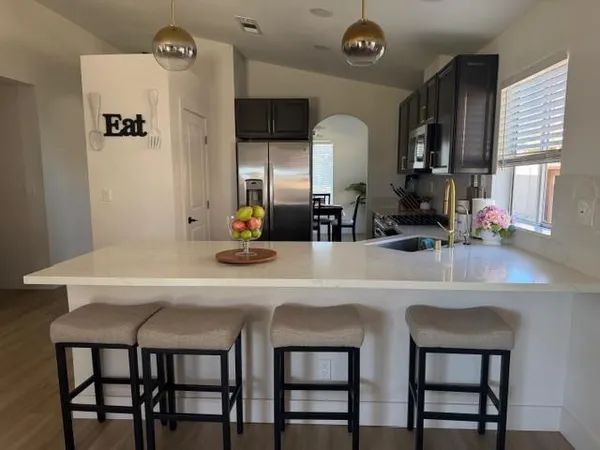 a kitchen with a table and chairs