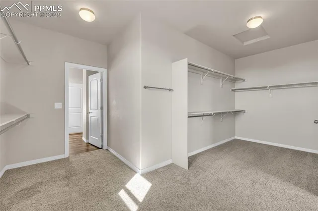 an empty room with a walk in closet and a window