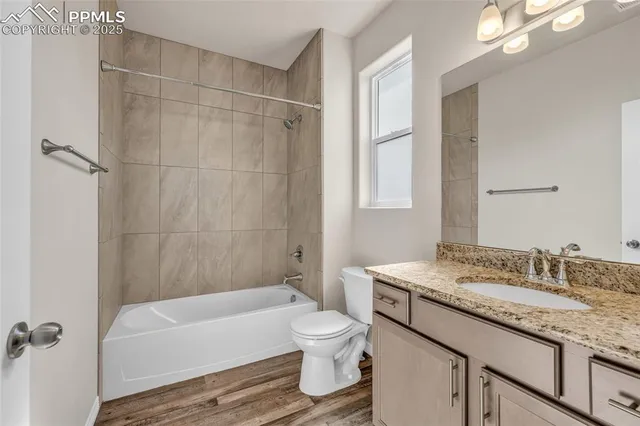 a bathroom with a granite countertop sink toilet tub and shower