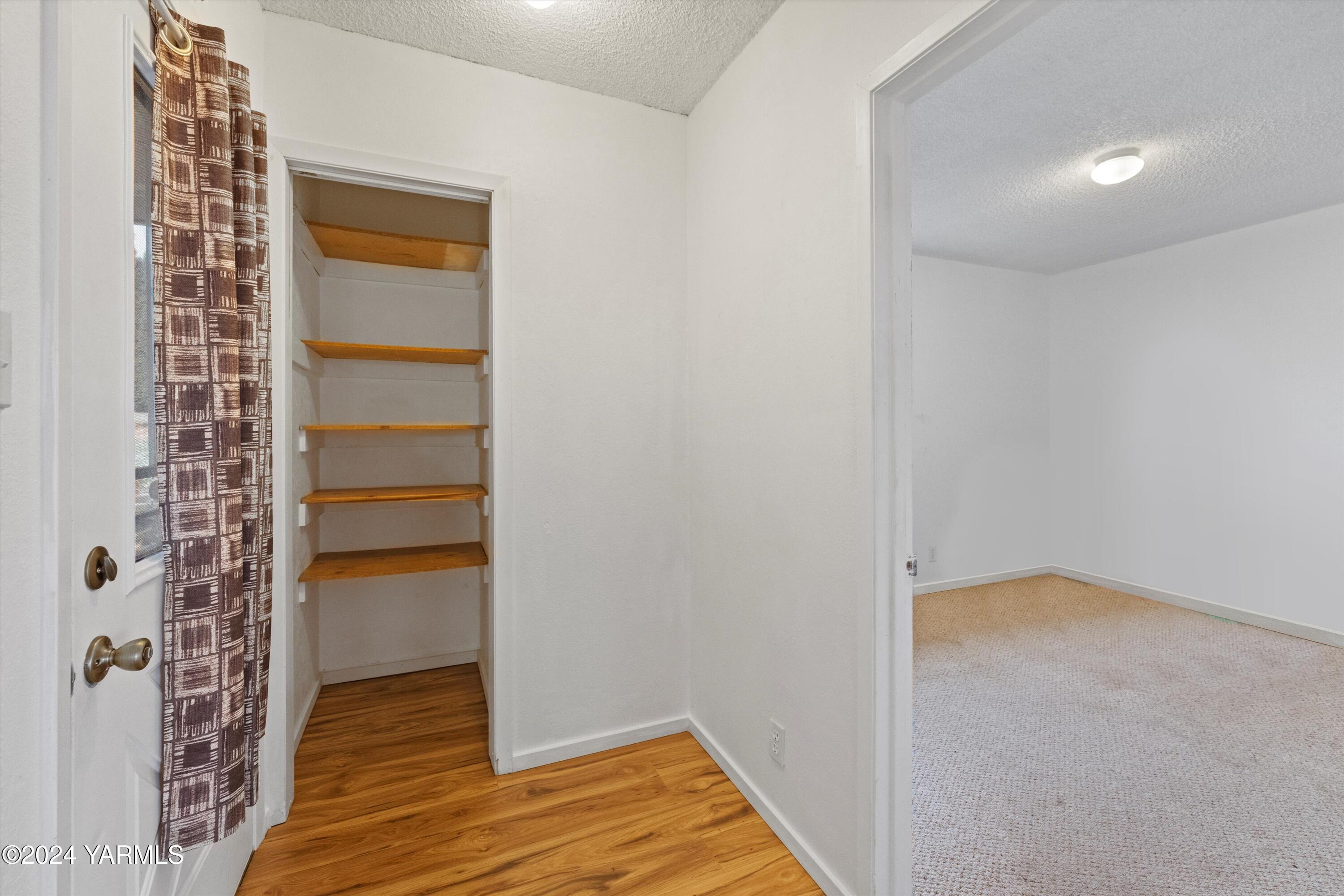 14901 Summitview Ext Road Yakima, WA 98908 - Photo 6 of 24 a view of an empty room with wooden floor and a window