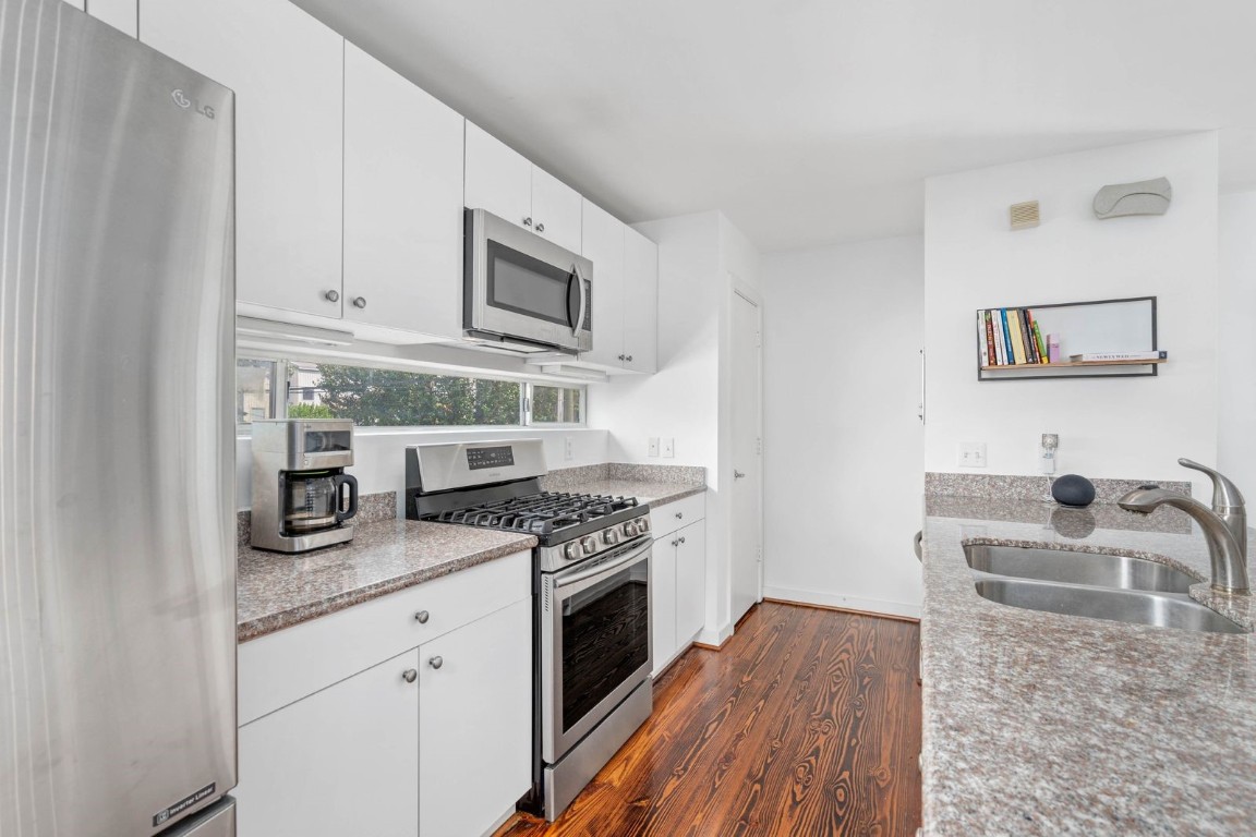 906 Andrews Street Houston, TX 77019 - Photo 14 of 23 a kitchen with stainless steel appliances granite countertop a stove and a sink