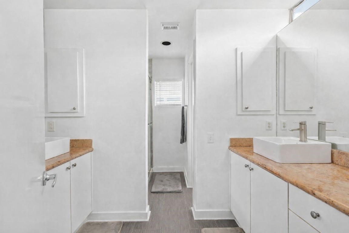 906 Andrews Street Houston, TX 77019 - Photo 17 of 23 a bathroom with a granite countertop sink and a mirror