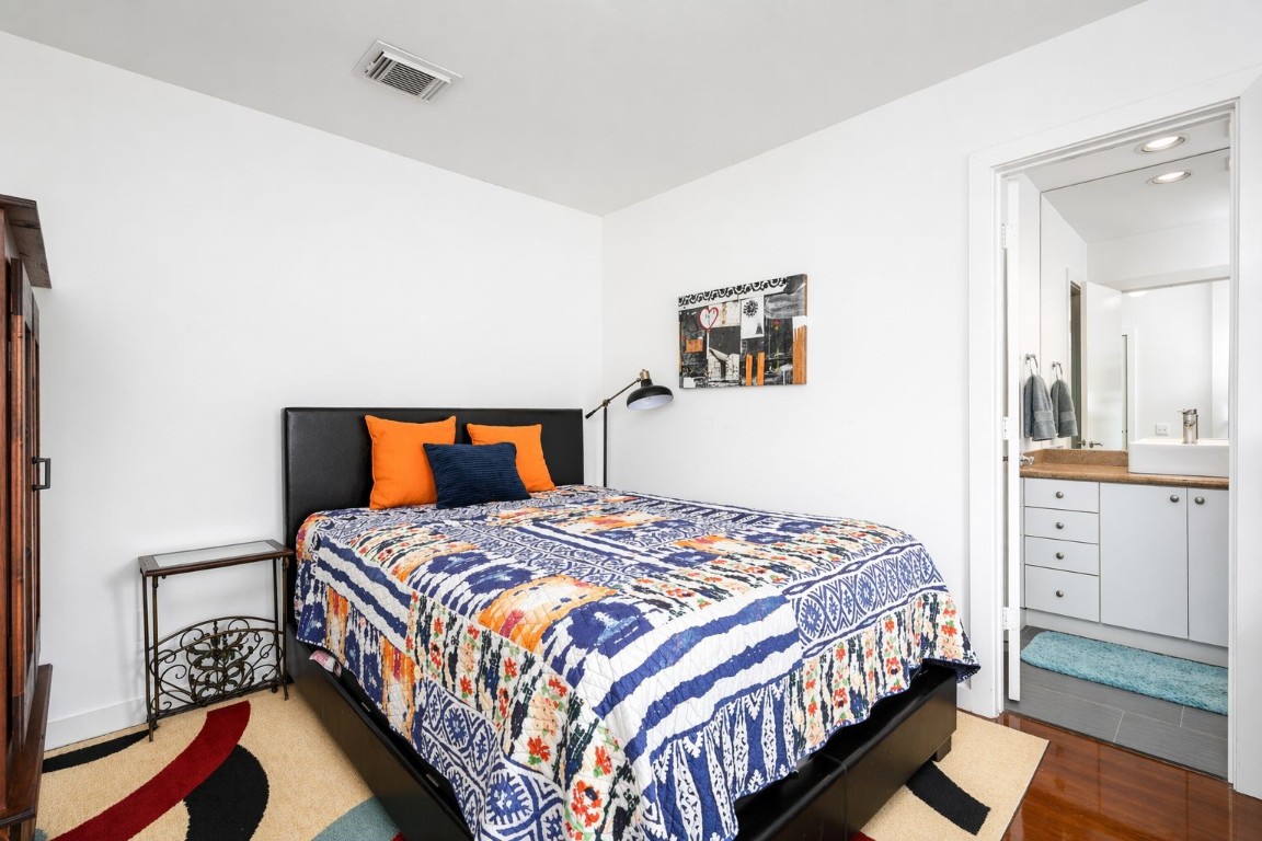 906 Andrews Street Houston, TX 77019 - Photo 6 of 23 a bedroom with a bed and cabinet