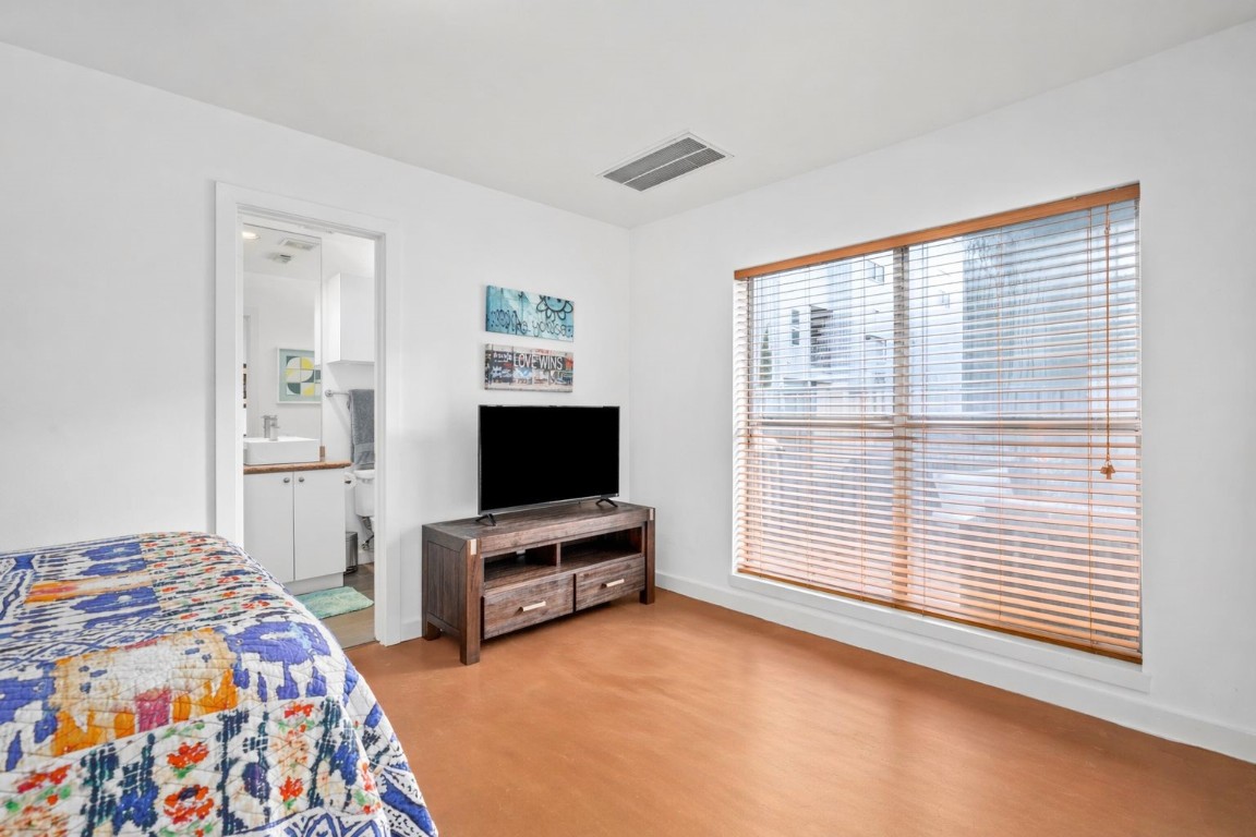 906 Andrews Street Houston, TX 77019 - Photo 7 of 23 a bedroom with a bed and a flat screen tv