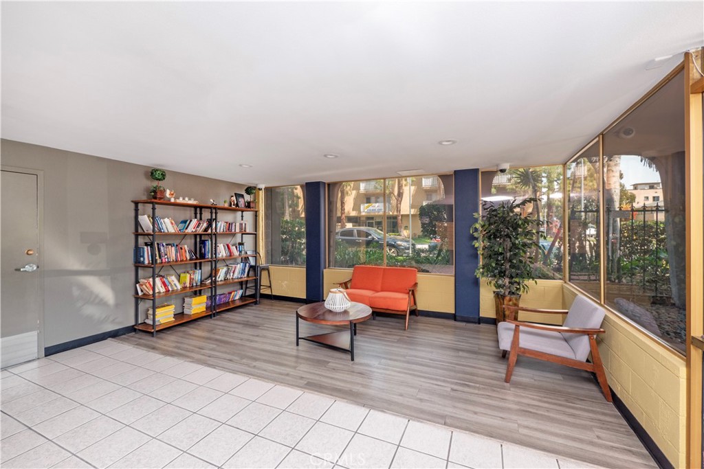 545 Chestnut Avenue, Unit 104 Long Beach, CA 90802 - Photo 12 of 48 a living room with furniture and a floor to ceiling window