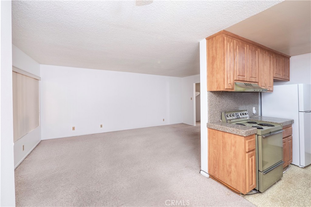 545 Chestnut Avenue, Unit 104 Long Beach, CA 90802 - Photo 24 of 48 a kitchen with stainless steel appliances granite countertop a stove a sink and white cabinets