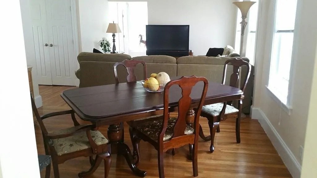 262 Brown Street, Unit 2 Waltham, MA 02453 - Photo 2 of 8 a view of a dining room with furniture and wooden floor